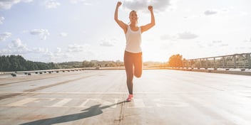 Woman runs over the finish line in a race