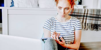 Woman sits on floor listening to music