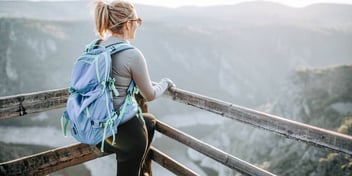 female hiker at the top of a mountain lookout