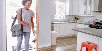 Woman walks alone into her apartment