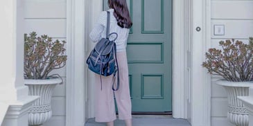 Woman walks into her front door