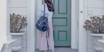 Woman walks into her front door