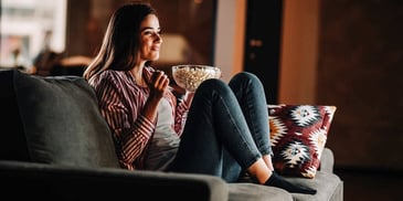 Woman watches a movie at home