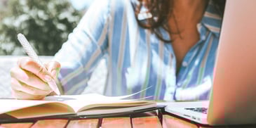 woman writing a divorce letter to her spouse to tell him the marriage is over