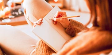 woman writing in her journal