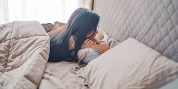 sad women alone in bed after being dumped by her spouse