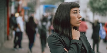 introspective young woman on the street